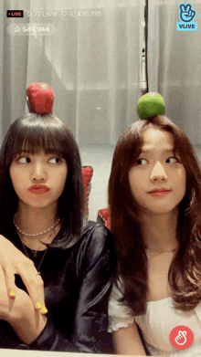 a woman with an apple on her head and a lime on another woman 's head