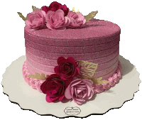 a cake with pink frosting and pink flowers is on a cake stand