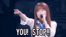 a woman singing into a microphone with the words " you stop " written below her