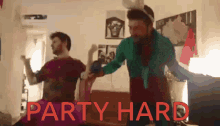 two men are dancing in a room and the words party hard are visible