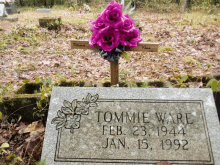 a gravestone for tommie ware with purple flowers on it