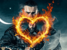 a man with a beard is holding an axe with a heart made of flames behind him