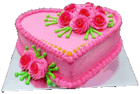 a heart shaped cake with pink frosting and roses on it