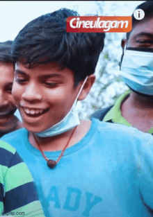 a boy wearing a mask and a blue shirt that says ady