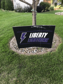 a sign for liberty lightning sits in the grass