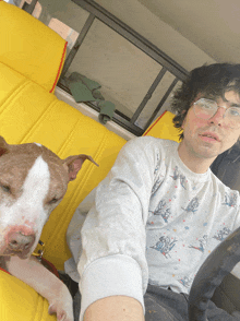 a man and a dog are sitting in the back seat of a vehicle