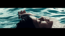 a woman is floating on her back in a pool