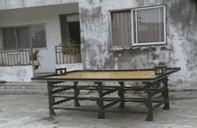 a ping pong table in front of a building