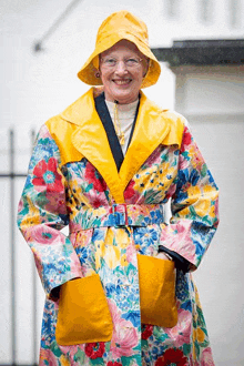 a woman wearing a yellow rain hat and a colorful coat