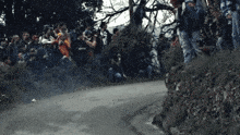 a man in a red shirt that says ' i love ' on it stands in front of a crowd