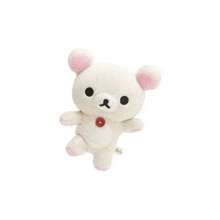 a white teddy bear with pink ears and a red button on its chest is sitting on a white surface .