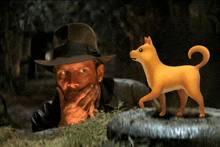 a man in a hat is looking at a dog that is standing next to him