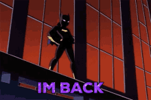 a cartoon of batgirl standing on the edge of a building with the words " im back " below her