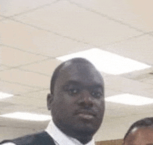 a man in a suit and tie is standing next to a woman in an office .