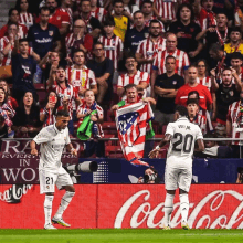 a soccer player wearing a number 20 jersey stands on the field