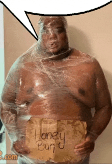 a man wrapped in plastic wrap holds a piece of paper that says honey bun