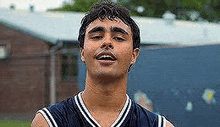 a close up of a man wearing a basketball jersey .