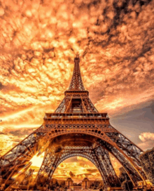 the eiffel tower is lit up at sunset in paris