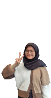 a woman wearing glasses and a hijab gives the peace sign