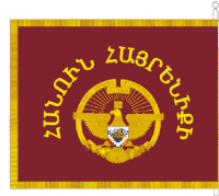 a red flag with a gold eagle and a crown and the words " zuertung " on it