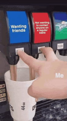 a hand is pressing a button on a soda machine that says wanting friends