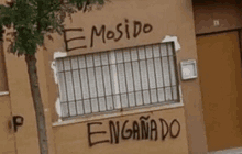 a building with graffiti on the side that says " emosido enganado "