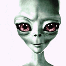 a close up of a grey alien with red eyes