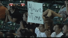 a boy holds up a sign that says altuve time