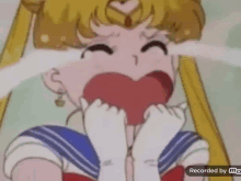 a cartoon of sailor moon crying with her eyes closed and a heart in her mouth .