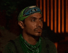 a man with a green bandana on his head