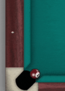 a pool table with a red ball on the edge