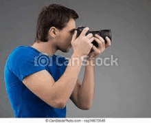 the man is wearing a blue shirt and taking a picture with a camera .