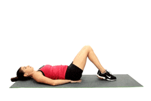 a woman in a red tank top and black shorts is laying on a yoga mat with her legs up .