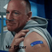 a man has a bandage on his arm and the name mr. pfizer is on the bottom