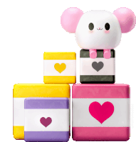 a stack of blocks with hearts on them and a cartoon character sitting on top