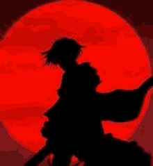 a silhouette of a person in front of a red moon .