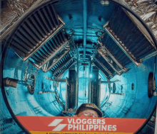 a man in a helmet stands in a tunnel with a sign that says bloggers philippines