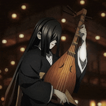 a woman with long black hair is holding a guitar