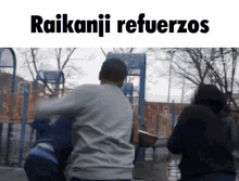 a group of people are standing in front of a playground with the words raikanji refuerzos on the bottom .