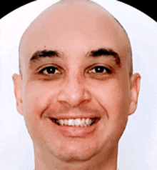 a bald man with braces on his teeth is smiling for the camera