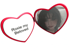 a heart shaped mirror that says roxie my beloved on it