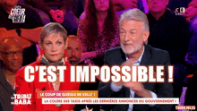 a man and a woman sitting in front of a crowd with the words c'est impossible