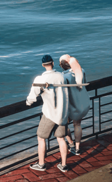 a man holding a sword stands next to a woman on a pier