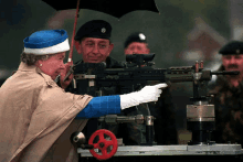 a woman in a blue hat is pointing a gun at something