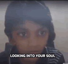 a young boy is looking into the camera with the words " looking into your soul " above him