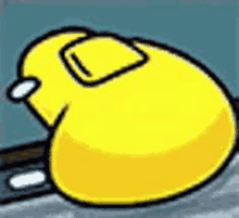 a yellow cartoon character is laying down on a gray surface .