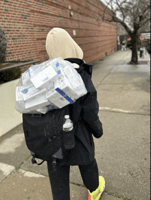 a person carrying a bottle of water and a large bag of cigarettes