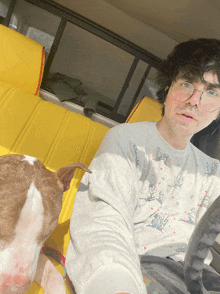 a man sitting in a car with a dog