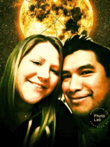 a man and a woman are posing for a picture with a full moon behind them