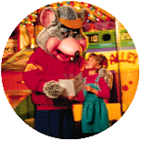 a chuck e cheese mascot is holding a little girl in his arms